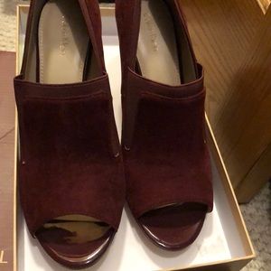 Burgundy suede open toe heels.